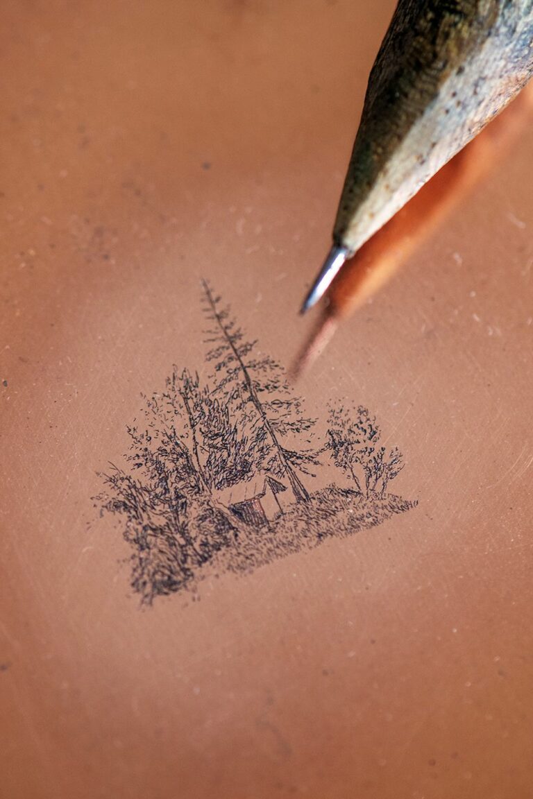 détail d'un paysage gravé sur une plaque de cuivre